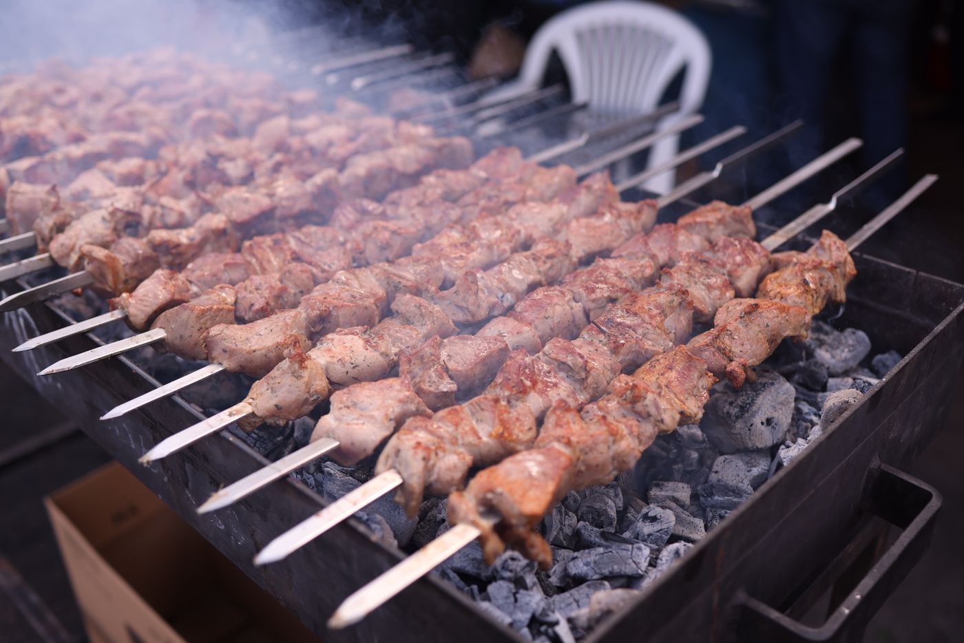 Kebab skewers cooking over charcoal